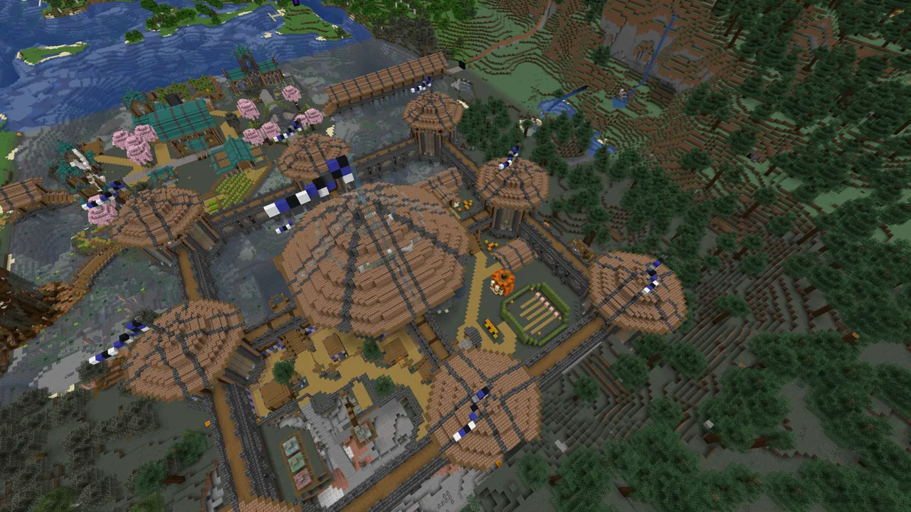 The spawn castle from above with round timber towers and banners